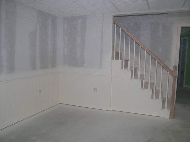 Family room looking toward the stairs (wainscoting painted)