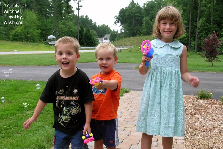 Michael, Timothy, and Abigail blowing bubbles