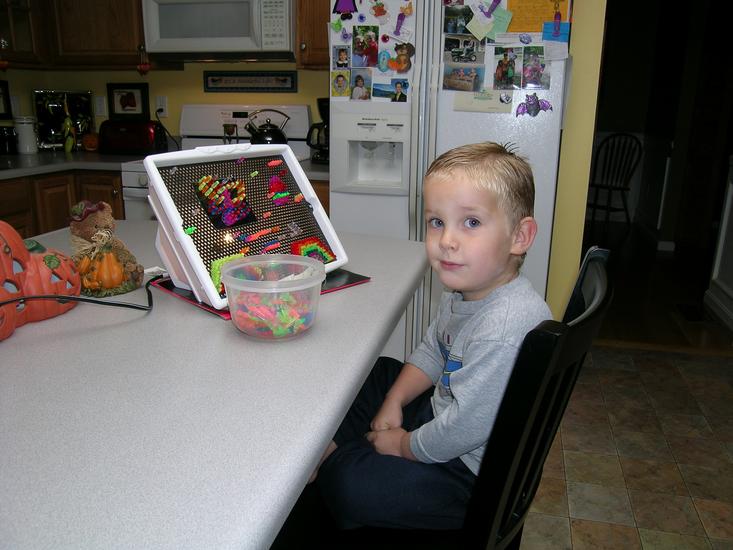 Timothy working with a Lite Brite