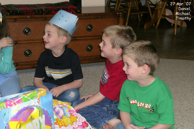 The boys watching Abby open her birthday presents