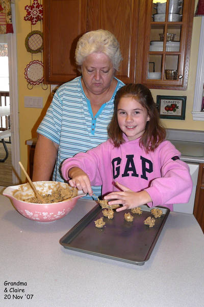 Grandma watching Claire make cookies