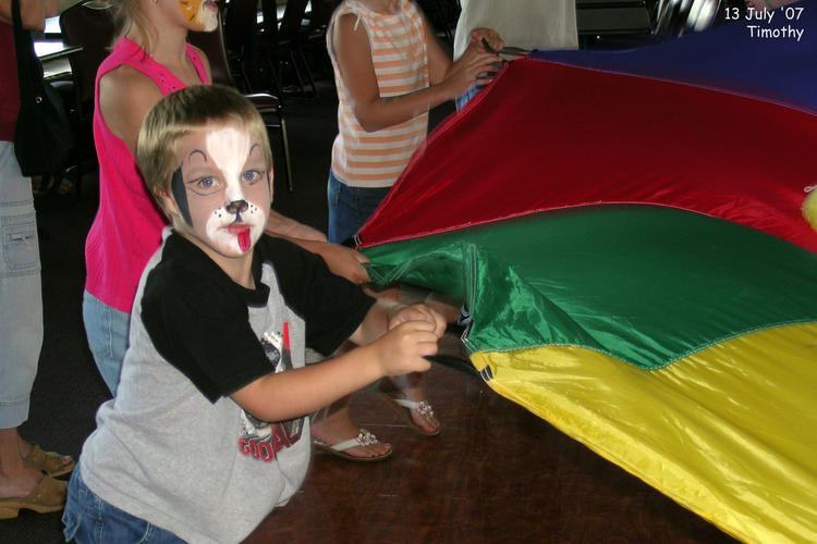 Timothy playing with the parachute