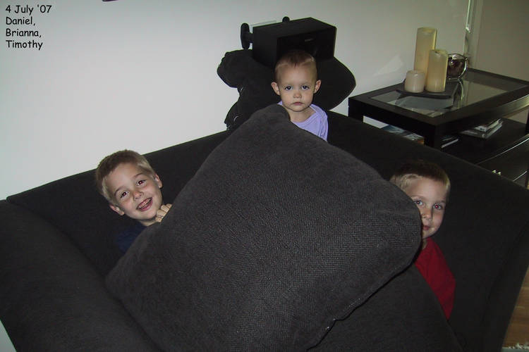 Daniel, Brianna, and Timothy playing with cushions