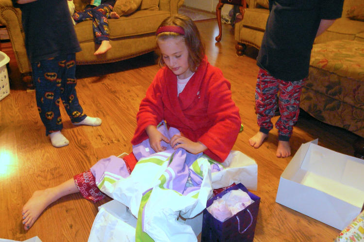 Abigail opening a gift