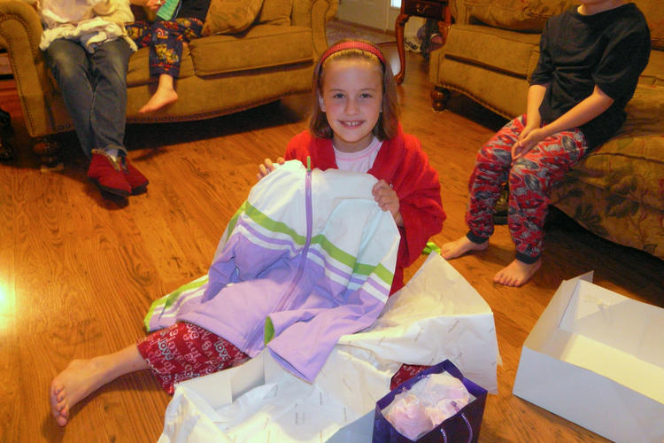 Abigail opening a gift
