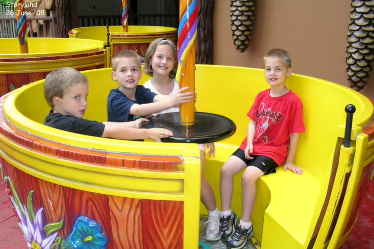 Kids riding the tea cup at Storyland