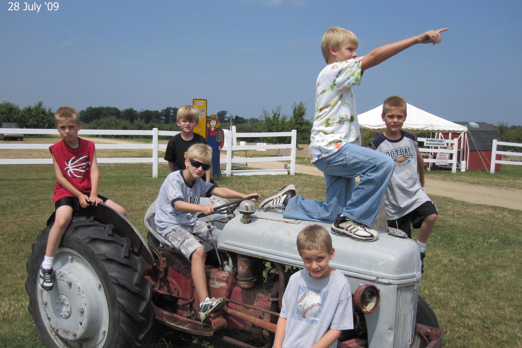 Some of the boy cousins commandeer a tractor