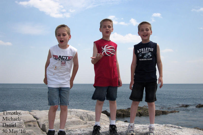 The boys conquer one of the large rocks on the NH coast